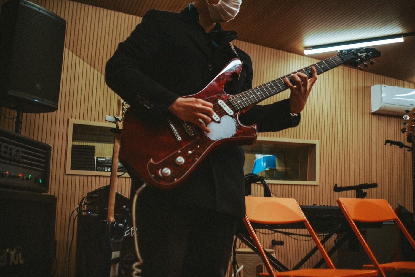 A guitarist rehearsing in the live room at Jam in SeouL